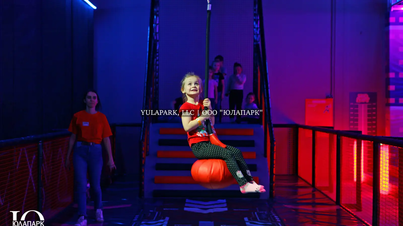 A family amusement park in Kaliningrad NEOPORT, a glowing bungee on which a girl is rolling.