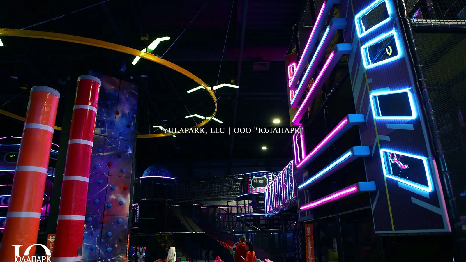 Children's playroom with a glowing skyrider, a climber, on which a child climbs in the style of the city of the future and with a lot of lighting