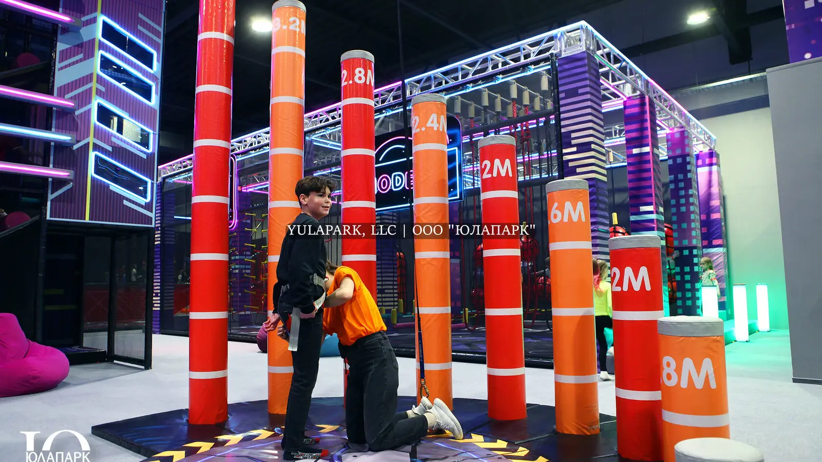 Interesting amusement park fun for kids, boy stepping up the columns.