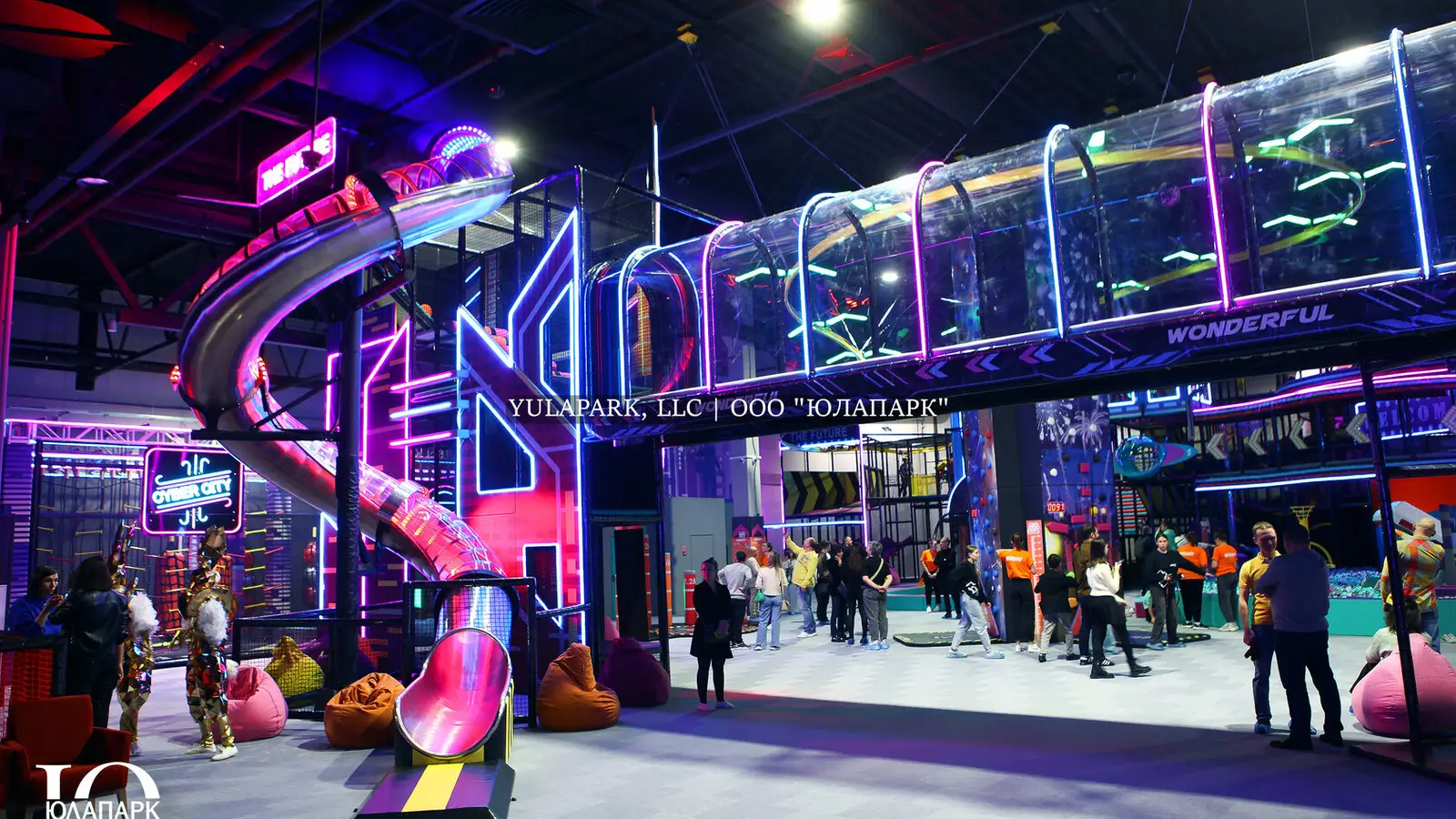 Family amusement park, children's playroom with a restaurant in Kaliningrad. A steel slide with lighting in the city of the future, a glass transparent bridge where children and parents have fun.