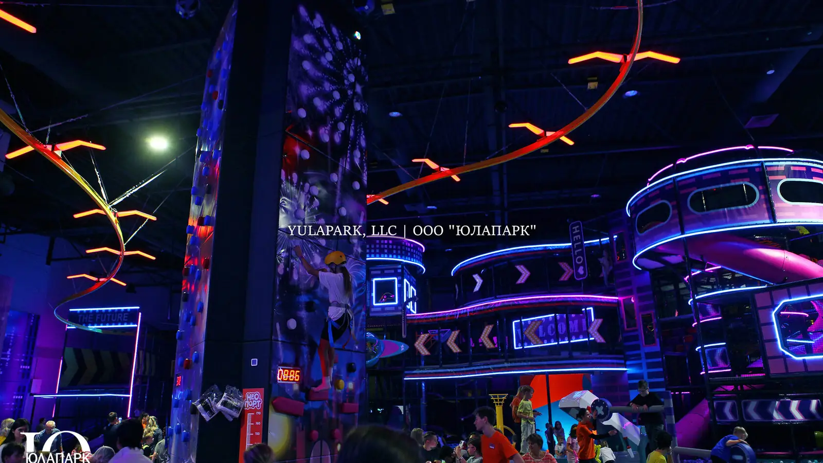 New play spaces and playgrounds. A children's playroom with a glowing skyrider, where a child flies over a park in the style of the city of the future and with a lot of lighting.